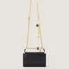 Bolso pequeño Pout de piel con cadena de dijes Bolso pequeño Pout de piel con cadena de dijes